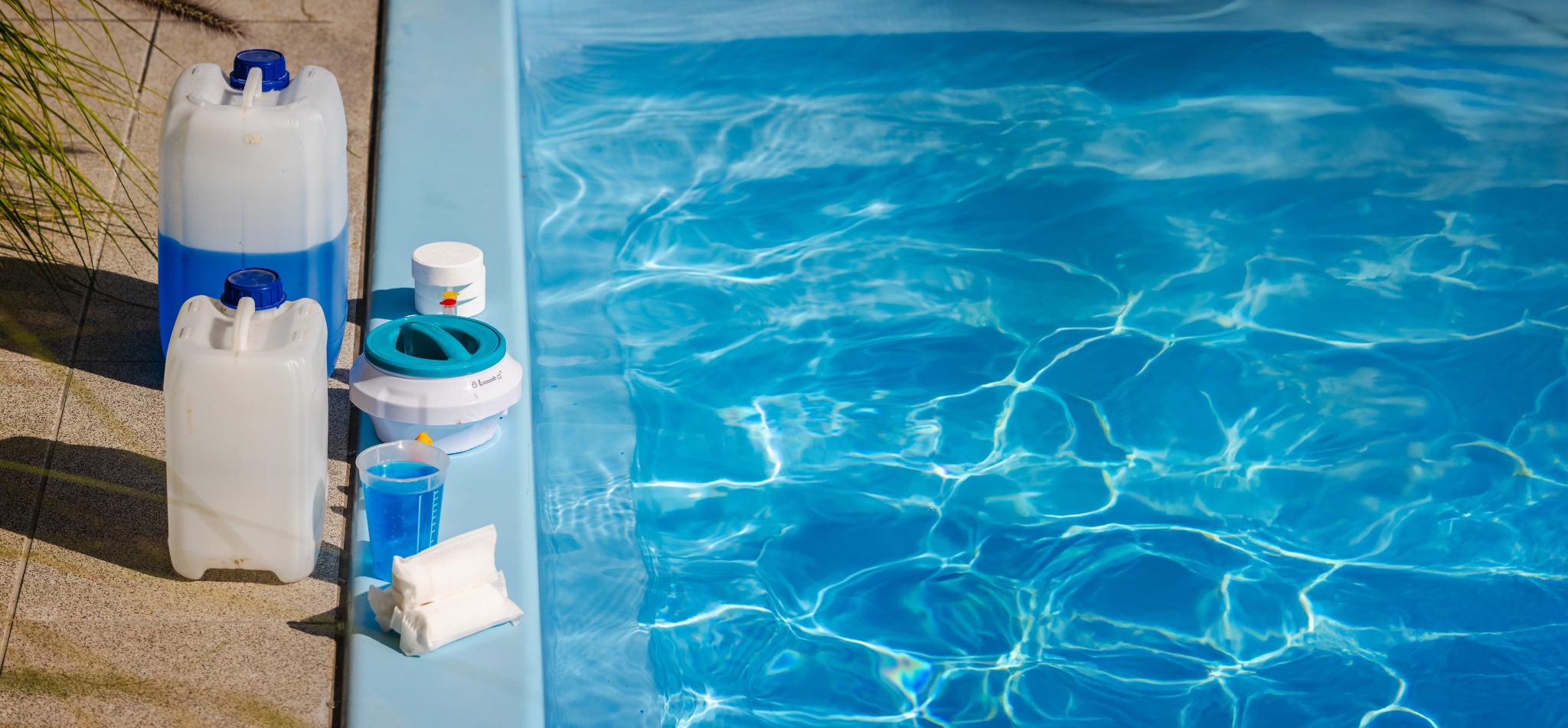 Pool maintenance supplies and floating dispenser at the water’s edge