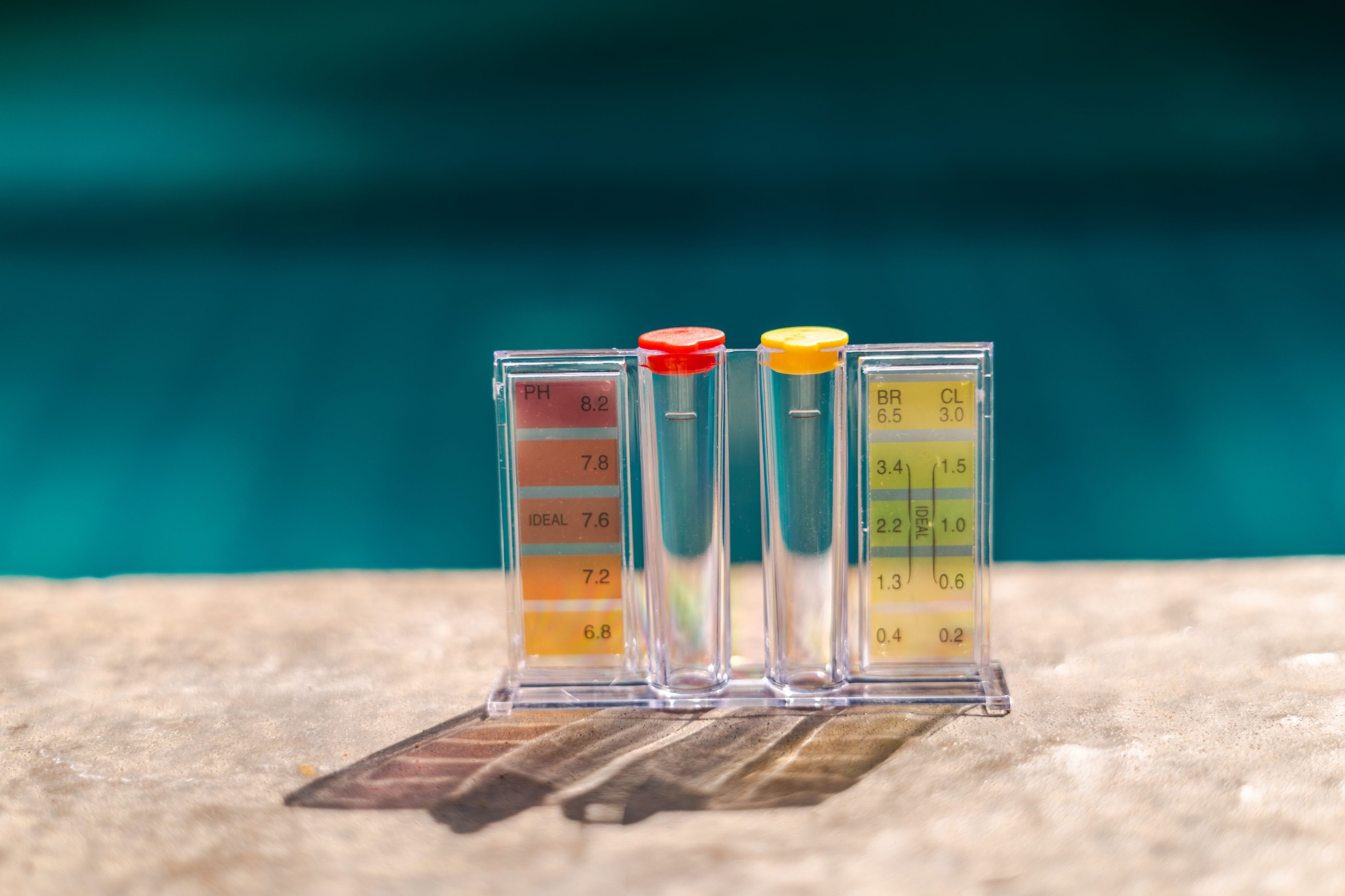 Pool water testing kit with red and yellow sample caps